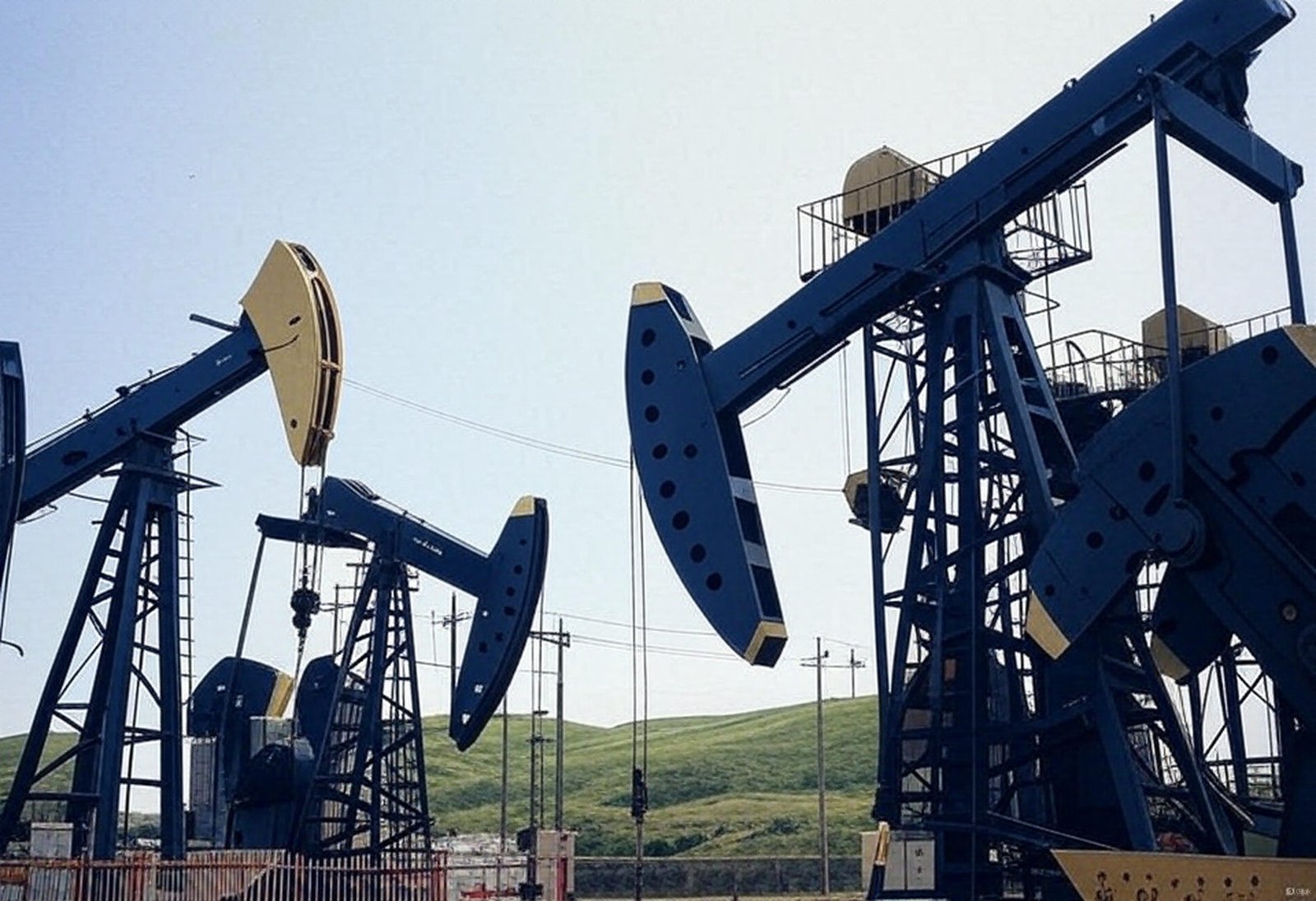 blue-and-white-pump-jacks-with-green-hills