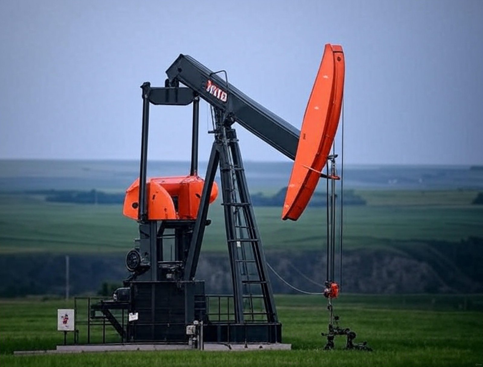 red-and-green-pump-jack-with-blue-sky
